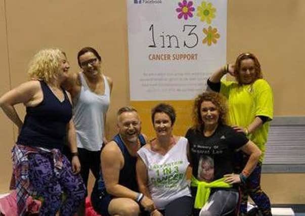 1in3's Karen McMeekan (kneeling, middle) with instructors John Davis and Kelly Nugent and other participants at the fundraising Zumbathon.  INCT 23-722-CON