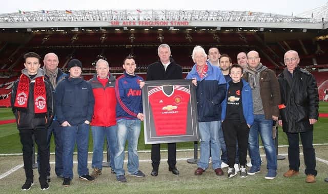 Members of the City of Derry Manchester United Supporters club getting presented with a signed jersey at Old Trafford last season to celebrate their 40th anniversary from ex-Man United and England defender Gary Pallister.