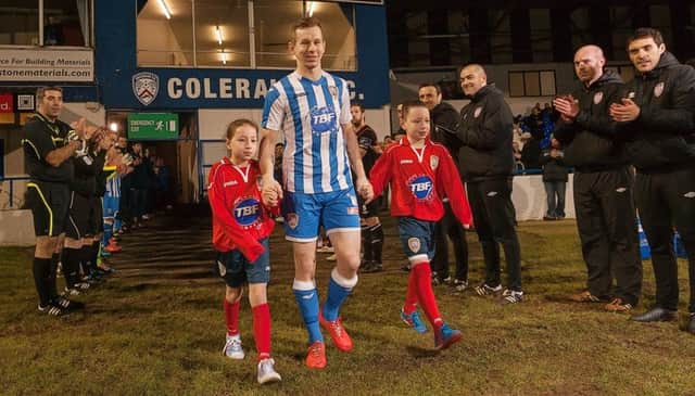Johnny, Faith and Jack Watt are welcomed on to the Showground pitch for Johnny's testimonial match between Coleraine and Derry City
. photo:Derek Simpson