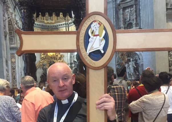 Coalisland Parish Priest, Fr Paul Byrne, with the Jubilee Cross of next in St Peter's Basilica in Rome. Photo via Coalisland Parish Twitter