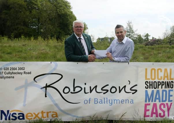 Gary Olphert of Robinson's Nisa Extra, Cullybackey Road presents a sponsorship cheque for Saturday's (28th May)stableford competition to Galgorm Castle Golf Club captain Ian Henry. INBT 22-176CS