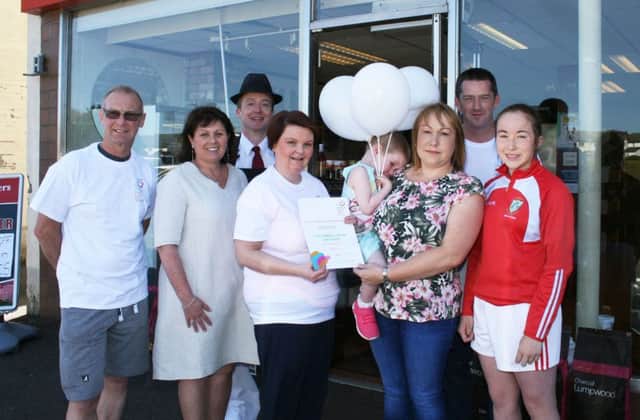 Donna Magill (third left) and Orla McMullan who were presented with a certificate from Jacqueline Wilkinson (second left) Administrator of the Children's Cancer Unit Charity at the Royal Victoria Hospital, in recognition of a donation of more than Â£5500. The total amount, which was handed over at Magill Butchers in Cloughmills last Thursday, was made up of a number of events organised jointly by Donna and Steven Magill and Donal Martin (pictured) as well as separate fund-raisers arranged by Orla.Also included is Brian Geddis (left) Springwell Running Club, and Erin and Niamh McMullan.