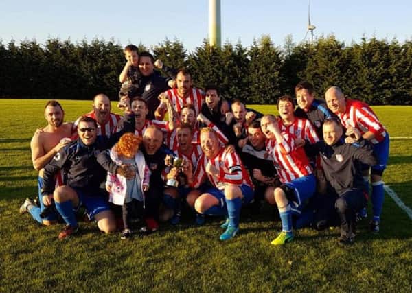 Atletico Antrim celebrate their Montgomery Cup success after beating Southside Rangers in the final.
