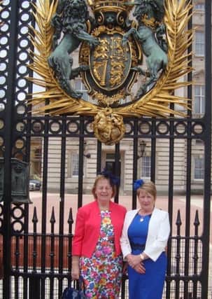 L-R Glenarm in Bloom founder Frances Wilson with volunteer Rosaleen Meban pictured outside Buckingham palace, where they were invited to a royal garden party in recognition of the community group's efforts. INLT-23-704-con