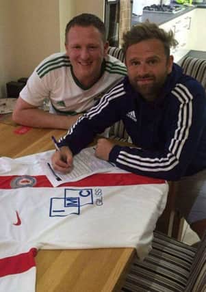 Lee Feeney (right) signs as the new Banbridge Rangers Manager. Looking on is his Assistant Manager Glenn Moffett.