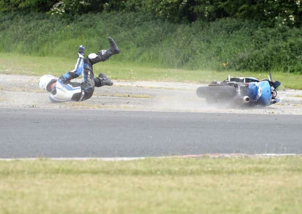 Jaimie Rea from Crumlin slid off his Suzuki in the Supertwins race. He was unhurt. Pictures: Roy Adams.