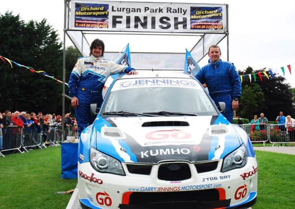 Garry Jennings and navigator Michael Morgan celebrate a previous Lurgan Park rally triumph.