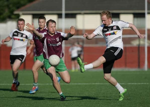 St Comgall's half-back Dylan Murdock goes in for the block during Sunday's game against Ardoyne.