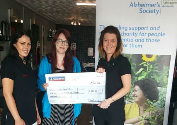 Rachel Andrews, manageress and Sasha Hartley, representing Close Cuts and Just Nails salon, present Aisleen Hamill, from the Alzheimer's Society with a cheque.  INCT 23-708-CON