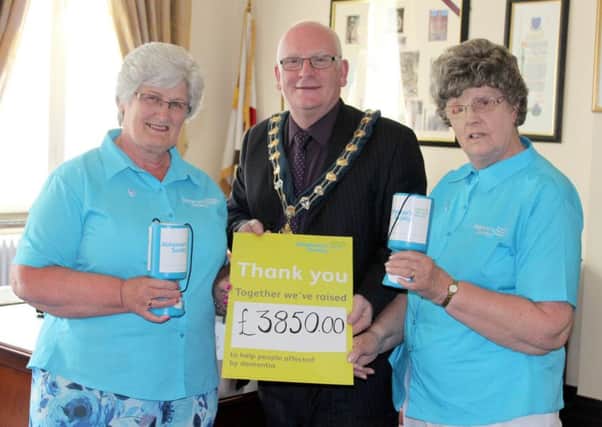 Mayor of Mid and East Antrim Borough Council, Cllr Billy Ashe, presents his fundraising total of Â£3,850 to Alzheimer's Society volunteers Margaret Gurney (L) and Margaret Turkington (R) at the Mayor's Parlour in The Braid, Ballymena.
This is one of Cllr Ashe's final activities as Mayor ahead of the Council's AGM this week where a new Mayor will be selected.