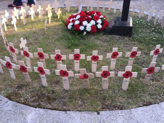 Poppy crosses were place in the Garden of Remembrance during Monday's service. INCT 23-752-CON