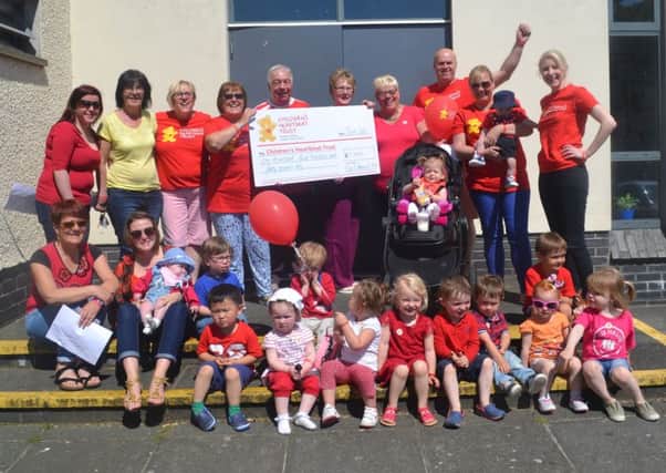 Members of the parents and toddlers group at Church of the Good Shepherd, Monkstown with their Â£1,440 cheque for the Children's Heartbeat Trust. INNT 23-595CON