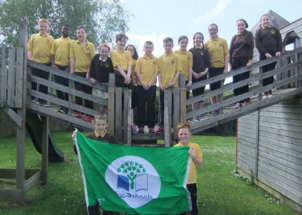 Children from Blessed Patrick O'Loughran PS in Castlecaulfield proudly hold their Eco Award