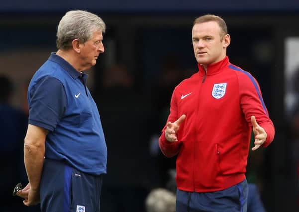 England's Wayne Rooney (right) speaks with manager Roy Hodgson