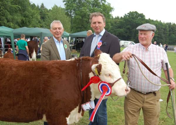 Judge Anders Mortensen (centre) from Denmark, congratulates Mervyn Richmond (right), from Co Fermanagh on winning the Hereford championship at Armagh Show 2016 with an excellent heifer. Adding his congratulations is Co Armagh Hereford breeder Robin Irvine.