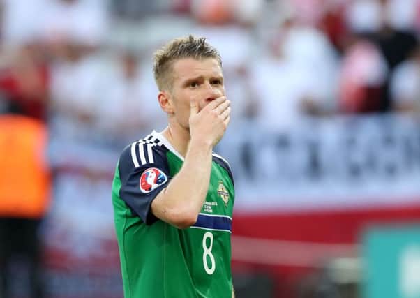 Northern Ireland's Steven Davis is dejected after Sunday's loss to Poland