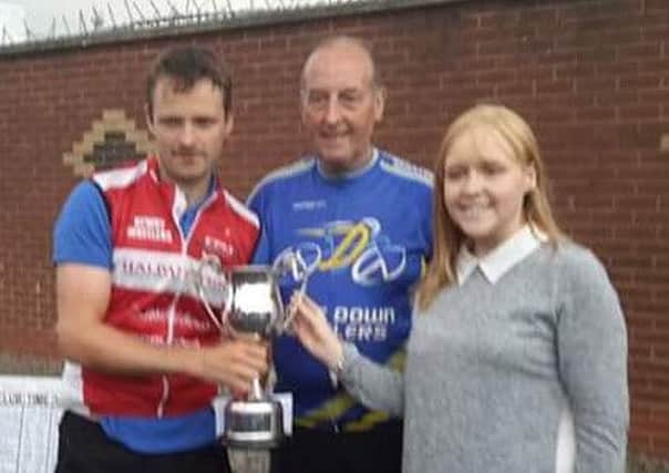 The winner of the Eric Maxwell Memorial 10 mile TT Sean Featherstone (Newry Wheelers) receives the trophy from Lauren Stoops as Wheelers Chairman Billy Maxwell looks on.