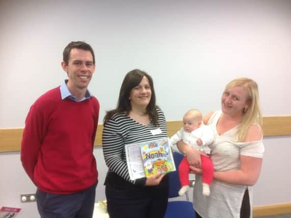 Pastor Peter Lawther and his wife Joanne giving out a certificate and gift to Tanya and baby Jessica. INCT 24-750-CON BAPTIST