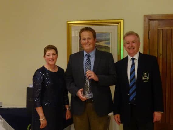 Winner of the Captains Gross Prize Darren Crowe receives his prize from Captain Colin Riddel and his wife Joan.