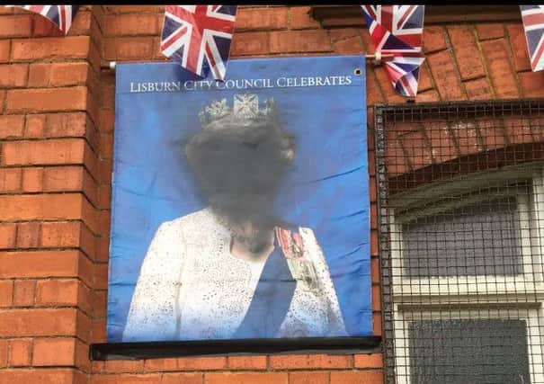 The defaced portrait of Her Majesty The Queen and graffiti placed on Derriaghy Orange Hall near Lisburn
