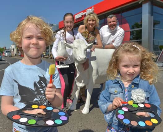 From left: Daniel Stephenson, Lisburn (9), Grace McKay, Dromara (11) and Georgia Rooney-Reid, Lisburn (4) prepare for the colouring competition with restaurant owners Anthony and Bronagh Campbell.