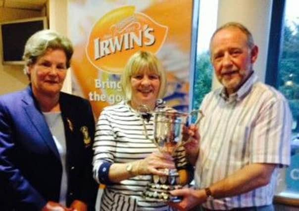 Valerie Courtney (centre) collects the Druim an Deur prize from Laura McAdam (lady captain) and Brian Irwin (Irwin's Bakery, tournament sponsors).