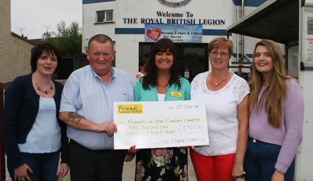 Robert Stewart, his wife, Margaret and daughters, Stacey (ledft) and Abbie present a cheque for Â£3920 to Claire Hogarth, Fund-raising manager for Friends of the Cancer Centre in Belfast, at the Royal British Lergion in Ballymoney.