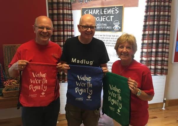 Dr Dickie Bar with his wife Janice and  Dave Linton of  Madlug