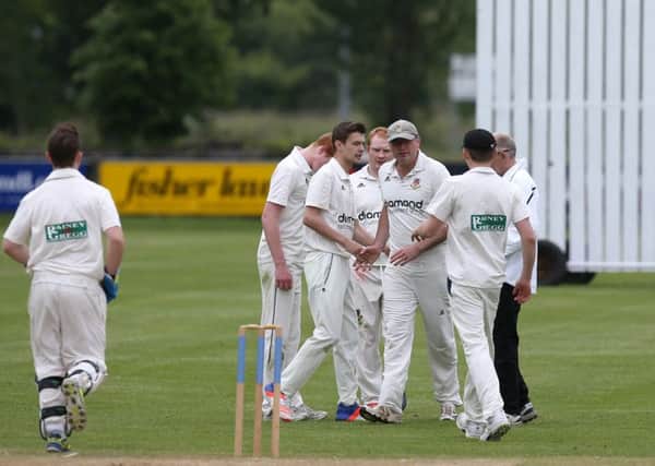 Michael Glass is congratulated by his team mates after his catch claimed the first wicket for Ballymena in Saturday's league game with Saintfield at Eaton Park. INBT 25-186CS
