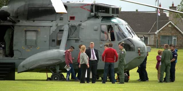 MLA Mervyn Storey at Ballymoney High School during the visit of the Royal Navy helicopter.
