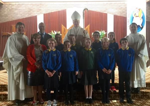 Bishop Noel Treanor, Rev Tim Bartlett, Rev Gabriel Lyons, Ms AM McDonnell pictured with pupils from schools.