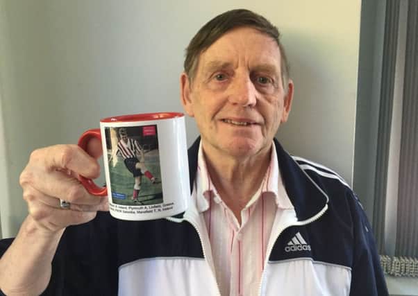 Albert Hewitt from Portadown showing off a gift presented to the football fan by former Northern Ireland manager Billy Bingham.