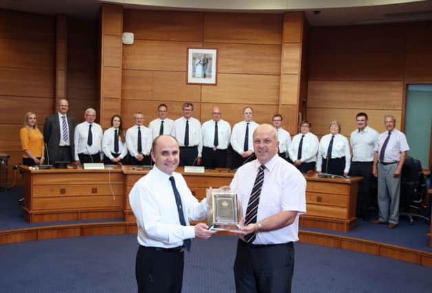Alderman James Tinsley presents Jonathan Gracey, Director of BB Northern Ireland with a gift to acknowledge this youth organisation being awarded the Queen's Award for Volunteering at a reception attended by Officers of the BB and elected membered of Lisburn & Castlereagh City Council.
