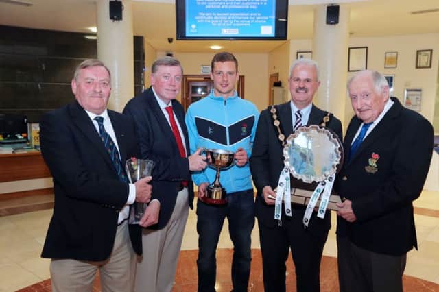 Pictured with the EY League Trophy and Champions Cup are: (l-r) Michael Bowden, President of Lisnagarvey Hockey Club; Alderman Paul Porter, former Chairman of the Council's Leisure & Community Development Committee; Jonny Bell, Captain of the winning 1st XI team; the former Mayor, Councillor Thomas Beckett and Bobby Howard, Patron of Lisnagarvey Hockey Club.