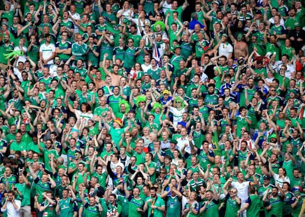 Northern Ireland fans cheer on their side in the stands during the UEFA Euro 2016, Group C match at the Parc Des Princes, Paris. Pic: Mike Egerton/PA Wire.