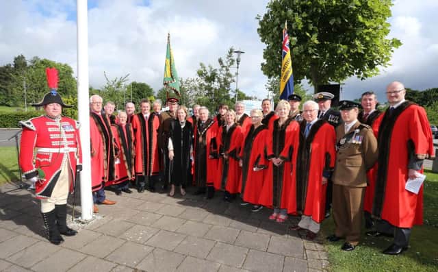 Pictured at the Raising of the Armed Forces Flag at Lagan Valley Island are the Mayor, Councillor Brian Bloomfield; Dr Theresa Donaldson, Chief Executive; elected members, members of the Armed Forces and Andrew Carlisle, Bugler.