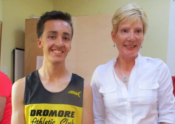 Councillor Janet Gray congratulates Dromara 5k and Fun Run male winner Daniel Dawson.