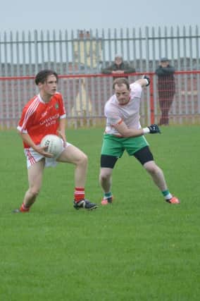Dolan's Ryan Watkins looks for a hand pass the Creggan Club's recent game against Drum at Piggery Ridge. It is Limavady's turn this weekend to try and stop the Gortnahey men. DER2316MC032