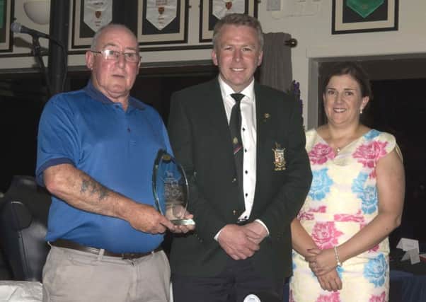 Captains Day 2016 winner Bernie Mulligan collects his prize from Captain Martin McCooe and  his wife Patricia.