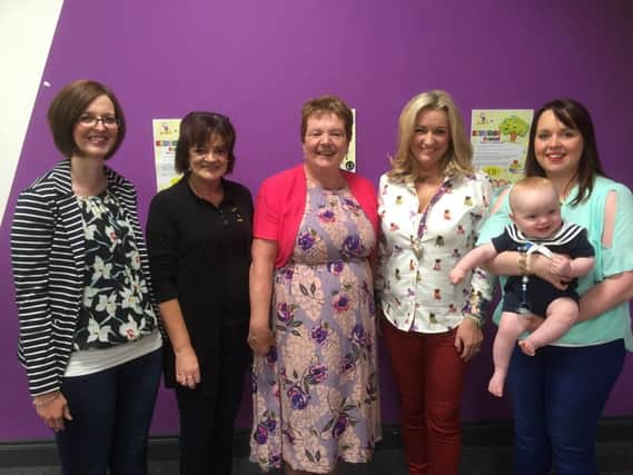 Looking forward to a new year at Kidzone from L to R: Karen Davidson, Ann Thompson - Playgroup Leader, Siobhan Fitzpatrick, Chief Executive of Early Years, Jo-Anne Dobson MLA, Kyla Emerson and her son Jude.