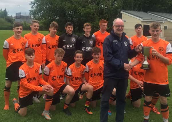 The Co Armagh Junior team are presented with the Dick Craig Memorial trophy.