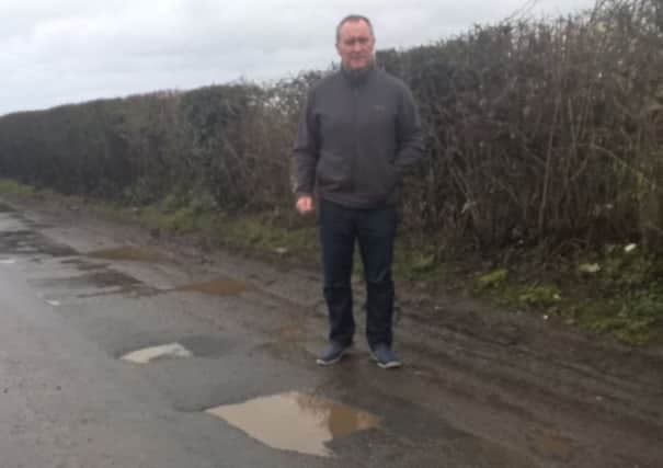 SDLP Cllr Declan McAlinden who is complaining about the lack of funding for potholes in rural areas such as Derrytrasna