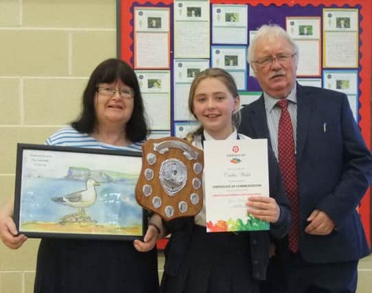 Caitlin Walsh, winner of the Texaco Art award, with Miss McAfee and Mr Magee at St Patrick's and St Brigid's Primary School Prize Day