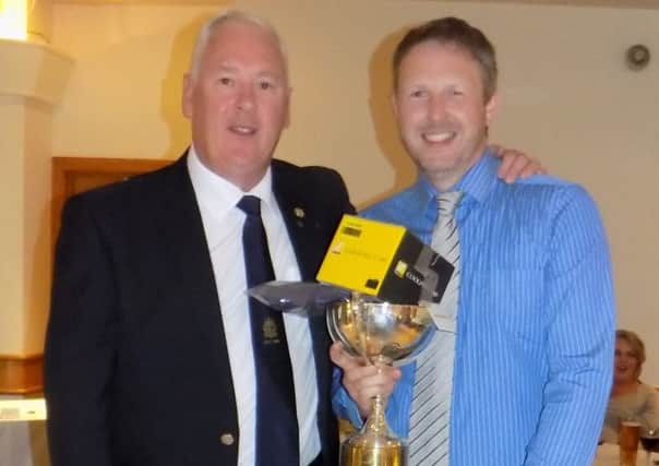 Lambeg Golf Club Captain Gerry McDonald presents Captain's Prize winner Andrew Smyth with his trophy.