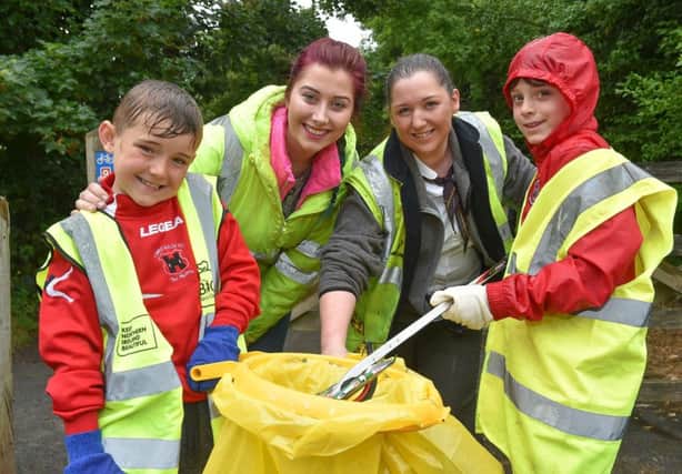 Helping to clean up the Lagan Tow Path are Reese Butcher from Lower Maze FC, Kara Neil, Sarah Heron from McDonald's and Shae McClure from Hillsborough Boys FC.