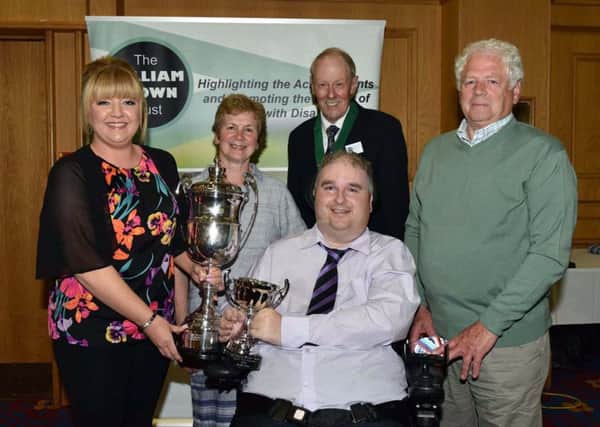 Peter Steele from Larne pictured with members of his family at the William Keown Trusts Personal Achievement Awards. Peter, who is confined to a wheelchair following a car accident in 2011, received the RUC Cup from Trevor Taylor, Deputy President of the William Keown Trust.  INLT 27-651-CON