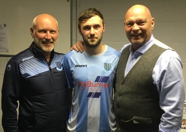 Ballymena United manager David Jeffrey and assistant Bryan McLoughlin welcome new signing Fra McCaffrey to the club.