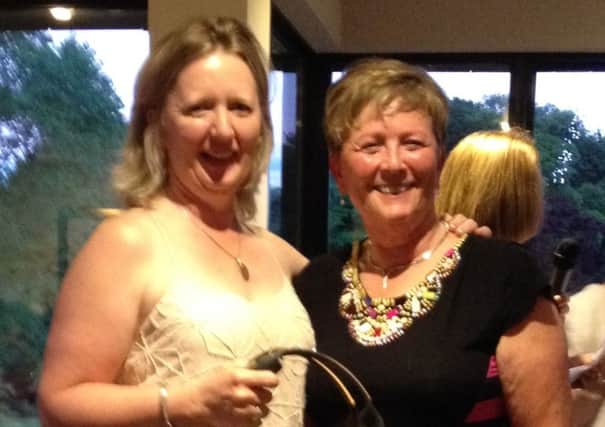 Carol Redpath collects the Lady Captain's Prize from the Lady Captain herself, Fionnuala McGrady.