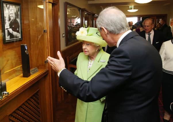 Press Eye - Belfast - Northern Ireland - 28th June 2016 

The Queen and The Duke of Edinburgh pictured at a Reception & Civic Lunch at Royal Portrush Golf Club, County Antrim

She is pictured with Sir Richard McLaughlin, Past Captain of Royal Portrush Golf Club viewing Darren Clarke's Open Trophy.

Photo by Kelvin Boyes / Press Eye