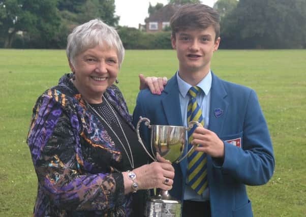 Ethan Williamson collects The Michael Aldred Cup from his grandmother, Anne Aldred, as this year's recipient. The trophy for sportsmanship and endeavour was presented by the Aldred family to Clounagh Junior High School in 1982 in memory of the former pupil.